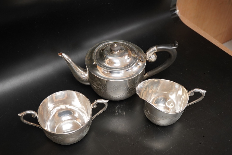 An Indian white metal three piece tea set, with engraved foliate decoration, gross weight 31.2oz.